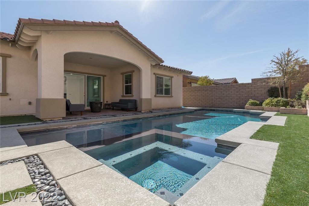 Finished Impact project: pool and raised spa area integrated with turf and hardscape